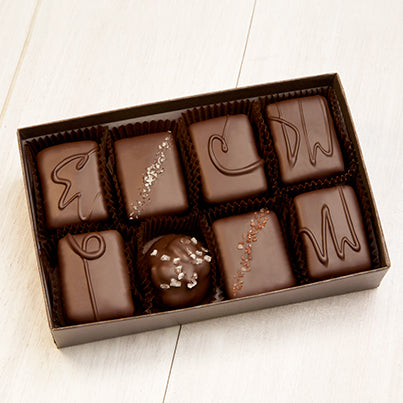 An open eight piece assortment. Various chocolates from the assortment can be seen.